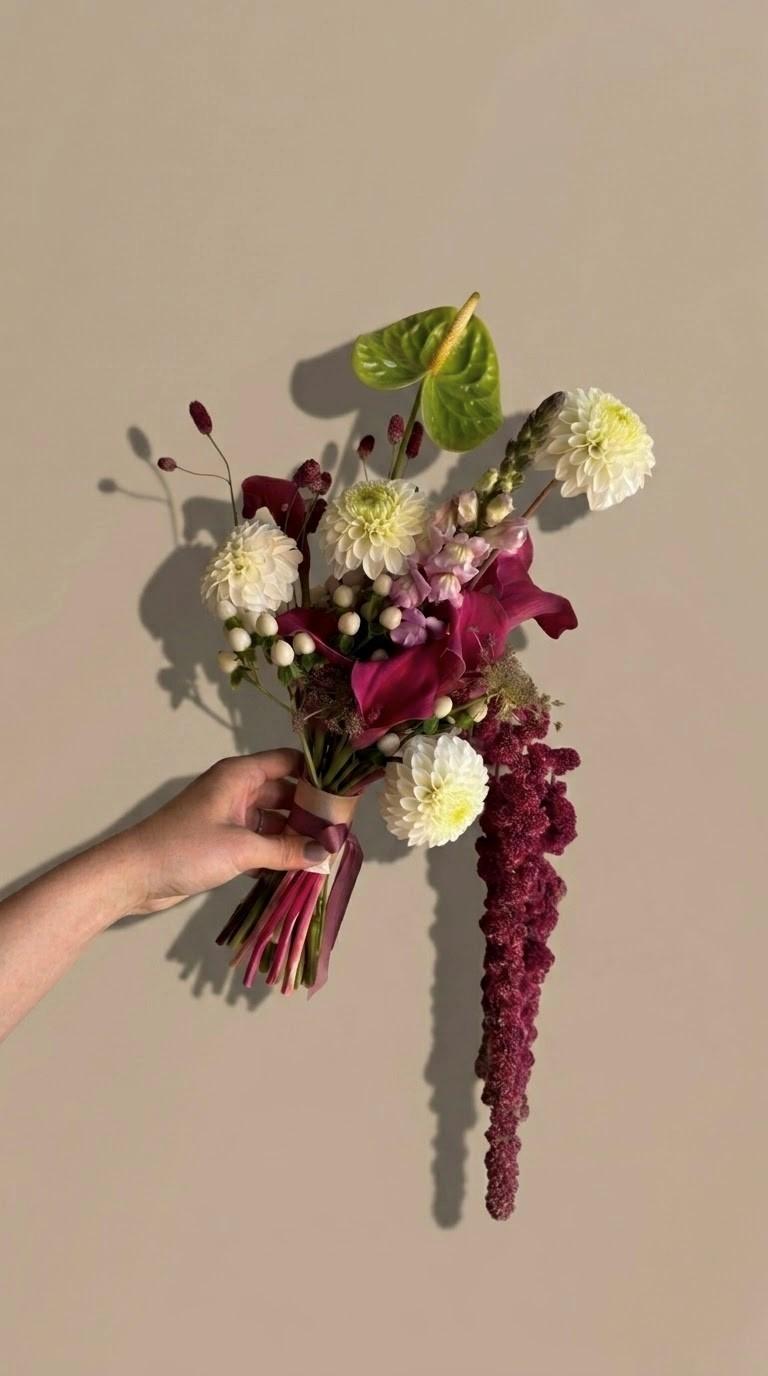 Bouquet da sposa nei toni del burgundy, con dalie bianche e calle scure